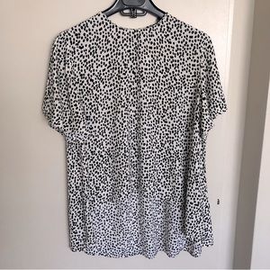 High-low polka dot short sleeve blouse.